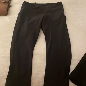 Lululemon black leggings worn pockets on side and back. Size 4